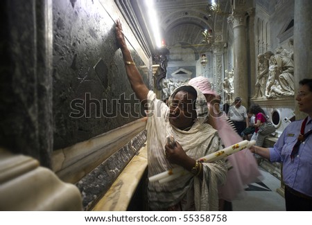 PADUA,ITALY - JUN 13:Feast of St.Anthony of Padua,the pilgrims pray at the tomb of St.Anthony parading with devotion,touching and kissing the marble plaque,June 13,2010 in Padua,Italy