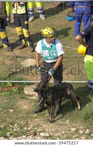 OSPITALETTO,ITALY - AUGUST 21: World Championship rescue dogs, a dog and its handler for the italian team to a test for the surface,August 21,2010 in Ospitaletto,Italy