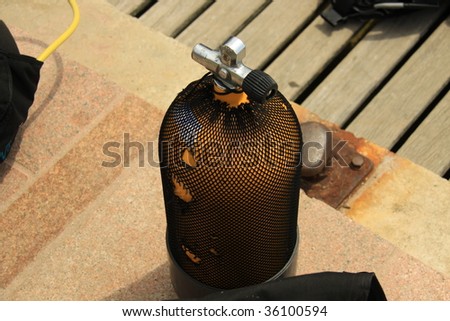 yellow scuba oxygen bottle on the deck
