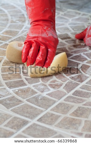 Close up of construction worker installing decorative tiles