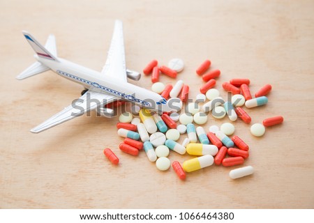 model airplane with multicolored pills from motion sickness clos