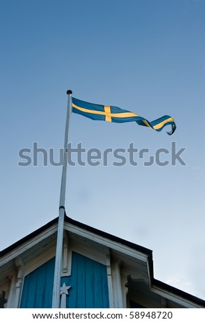 Old wooden house and sweden flag