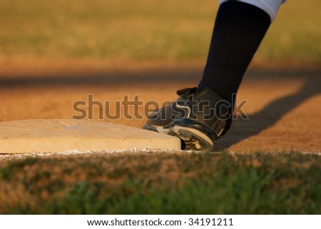 Baseball runner\'s foot on base ready to run