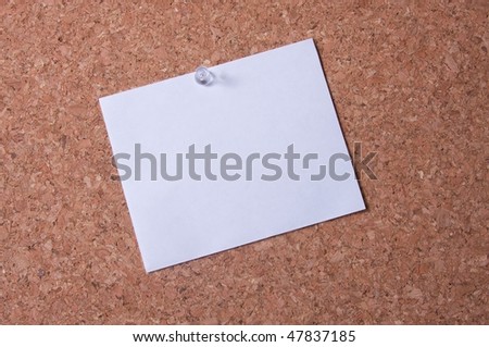 Large blank white note  posted on cork board.  Space available to add your own text/graphics.
