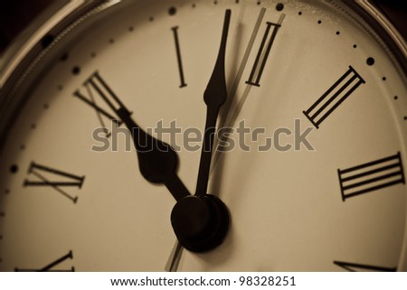 Close up of clock with hands showing a little after midnight and with movement of second hand.
