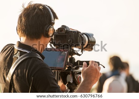 Video camera man operator working with professional equipment,filming recording