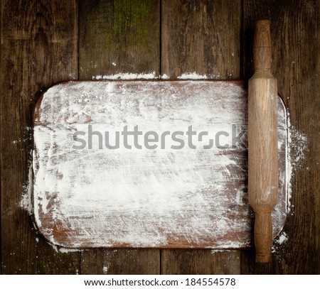 Rural vintage wood kitchen table with blank cook book and cooking tools. Background with free recipe text space.