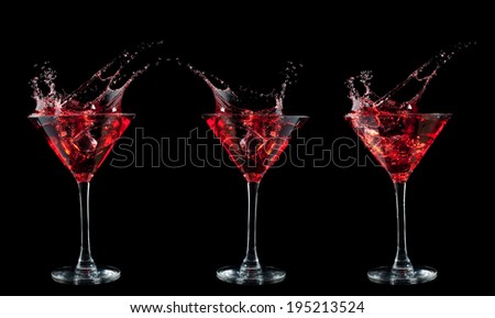 red cocktail splashing into glass on black background
