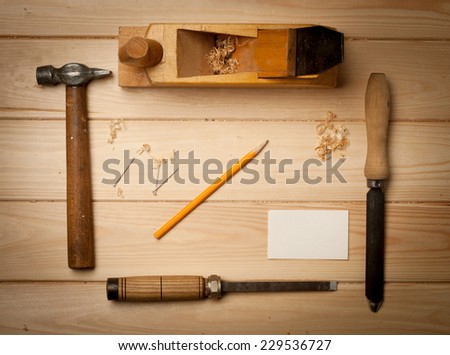 joinery tools on wood table background with business card and copy space