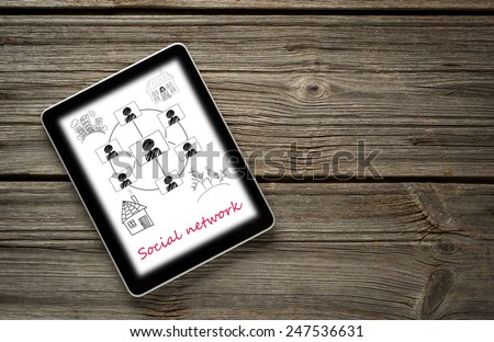 Digital tablet computer with  social networks concept isolated screen on old wooden background