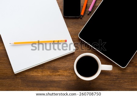Tablet computer with stickers,cup of coffee and on the wooden table