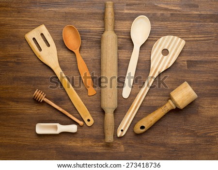 Wooden kitchen tools on vintage wooden background. Top view.