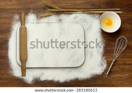 Rural vintage wood kitchen table with blank cook book and cooking tools. Background with free recipe text space.