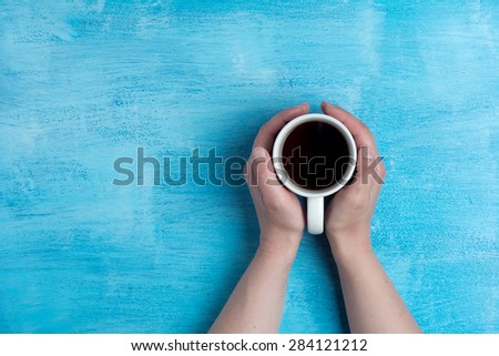 Woman holding hot cup of coffee