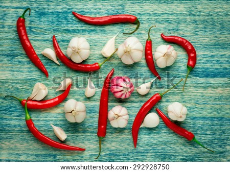 Red Hot Chili Peppers with herbs and spices over wooden background - cooking or spicy food concept.