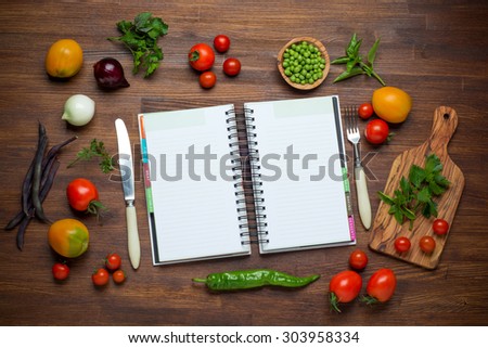Fresh Organic Vegetables and Spices on a Wooden Background and Paper for Notes. Open Notebook. Diet. Dieting.