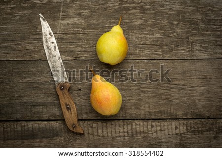 fresh ripe organic pears on a rustic wooden table.