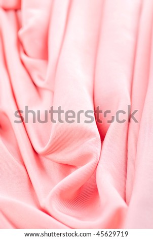 Pink folded cloth background close up
