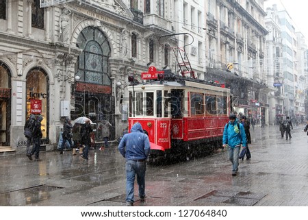 ISTANBUL,TURKEY-JAN UARY 7: Unidentified pedestrians walk down Istiklal Street on a snowy day on January 7, 2013 in Istanbul, Turkey.Istiklal Street is one of the popular destinations in Istanbul.