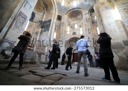 VAN,TURKEY-APRIL 28: Unidentified tourists visiting the Akdamar Church.Armenian Church of the Holy Cross stands on Akhtamar Island (Akdamar) in Lake Van on April 28,2015 in Van,Turkey.