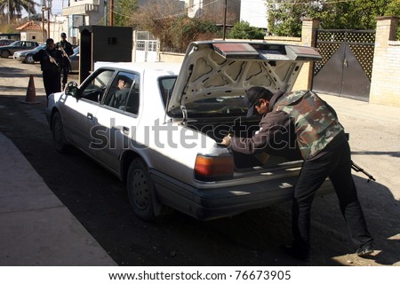 KIRKUK, IRAQ - FEBRUARY 2: Unidentified Iraqi soldiers check a car at a check point on February 2, 2007 in Kirkuk, Iraq.