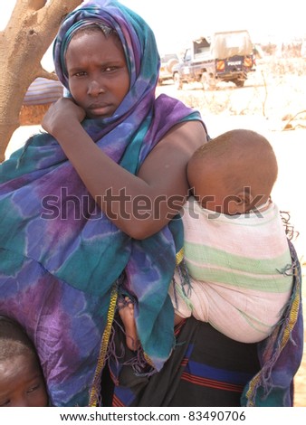 DADAAB, SOMALIA-AUGUST 15: Unidentified woman & children live in the Dadaab refugee camp where thousands of Somalis wait for help because of hunger on August 15, 2011 in Dadaab, Somalia.