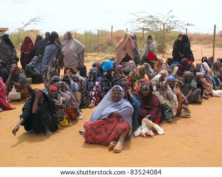 DADAAB, SOMALIA-AUGUST 15: Unidentified men, women & children wait for relief aid in the Dadaab refugee camp where thousands of Somalis end up due to hunger on August 15, 2011 in Dadaab, Somalia.