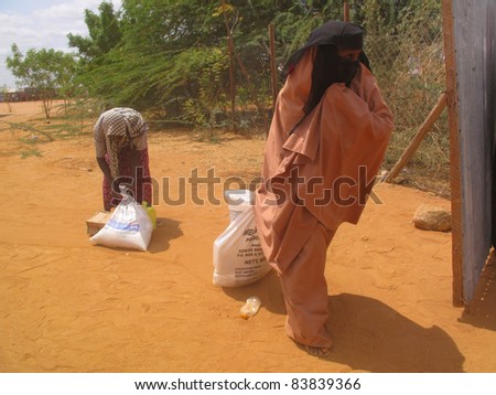 DADAAB, SOMALIA-AUGUST 15: Unidentified women wait for relief aid in the Dadaab refugee camp where thousands of Somalis end up due to hunger on August 15, 2011 in Dadaab, Somalia.