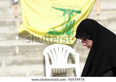 TYRE,LEBANON-OCTOBER 23: An unidentified Lebanese woman is praying near the grave of her family who died in Israel bombardment in Qana on October 23, 2006 ,in Tyre, Lebanon.