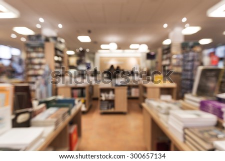 Out of focus shot from a book store, looking down the store towards the counter with customers standing by it. Great for use as a background or backdrop
