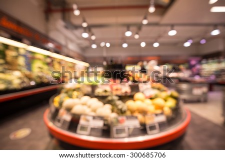 Fruit stand in a supermarket, out of focus shot for use as a background or backdrop.