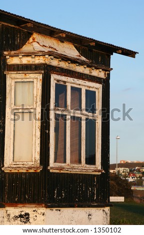 Big window on an old house in massive disrepair and is past its prime