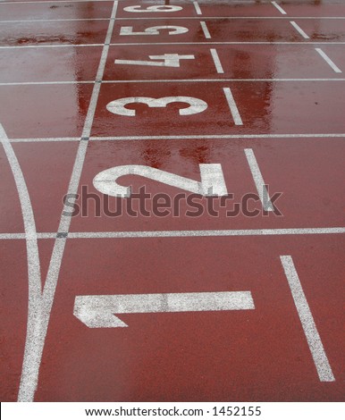 Running track shot from the start line with numbered lanes showing numbered from 1 to 6