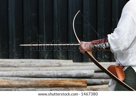 medieval Archer getting ready to shoot arrow at target