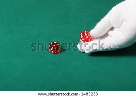Dices being thrown in a craps game, or any kind of dice involved game, Dices are a clear red color on a green felt table