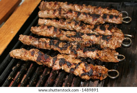 Meat being barbecued on a gas grill
