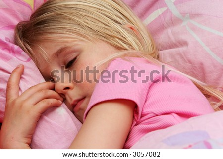 A little girl about to fall asleep, very drowsy