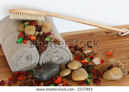 A still live of spa items, set up on solid oak, very soothing eartly colors,