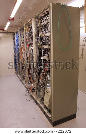 chaotic mess of network cables in a network routing room