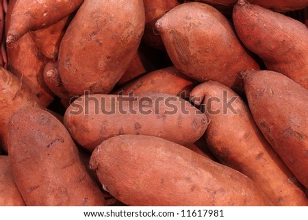 pile of sweet potatoes at a farmers market