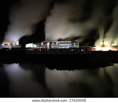 Geothermal powerplant at night in winter, steam time blurred, unreal feel to the image, clean energy production
