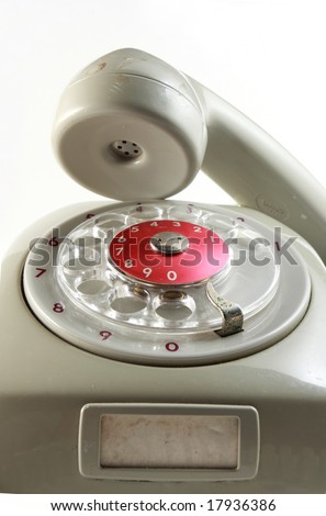 Old analog antique grey telephone with dial wheel, non digital