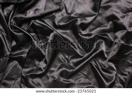 Black colored satin shot from above with creases and folds creating all sorts of shapes and shadows