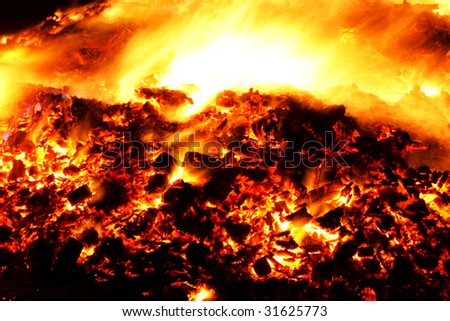 A fire burning in wood embers, long exposure creates the effect of the power and intensiveness of fire