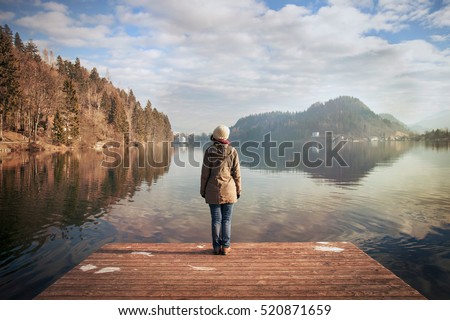young woman looking over the lake, winter atmosphere in Bledâ??s lake