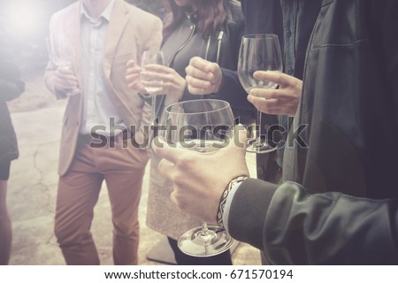 group of friends drinking wine, people is socializing and having a fun (this version has slightly desaturated colors)