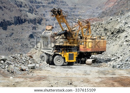 Kremenchug, Ukraine - 26 June 2010. Heavy mining dump truck being loaded with iron ore