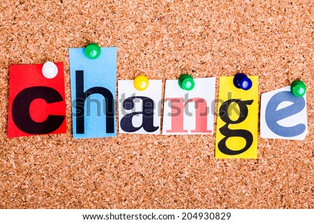 The word Change in cut out magazine letters pinned to a cork notice board