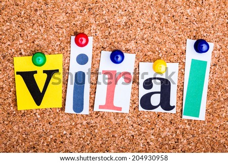 The word viral in cut out magazine letters pinned to a cork notice board