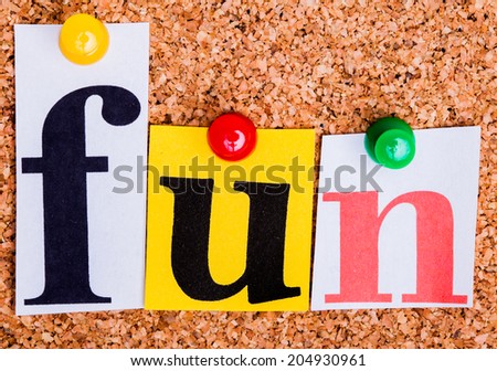 The word fun in cut out magazine letters pinned to a cork notice board.